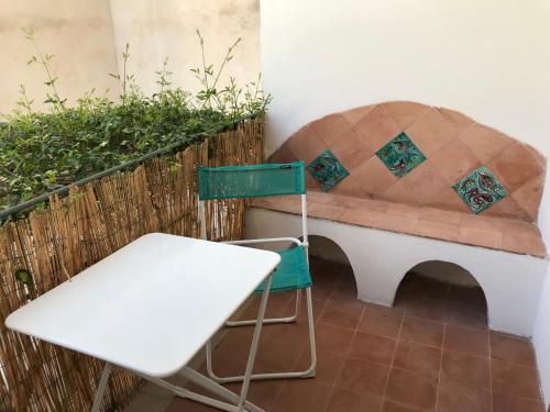 a chair and a bench on a balcony at La Casa del Giudice in Atrani