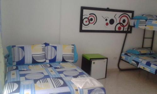 a bedroom with a bed with a blue and white comforter at Hotel Bellavista Isla del Sol in Prado