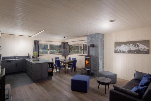a kitchen and living room with a couch and a table at pure mountain BASE in Erpfendorf