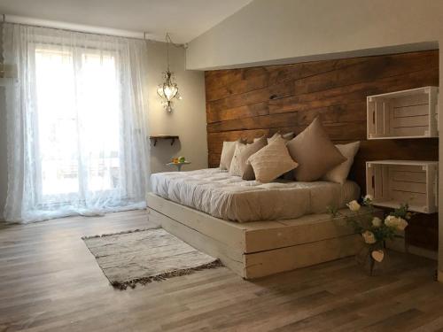 a bedroom with a large bed with a wooden wall at le Piagge in Viterbo