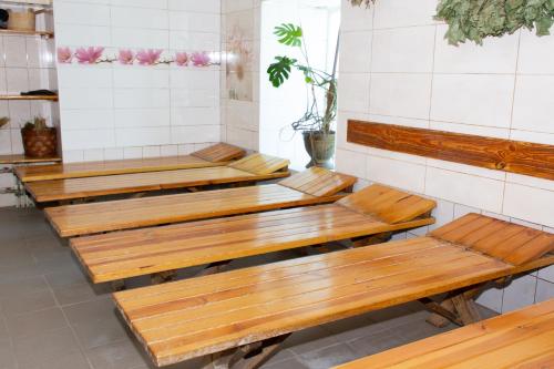 a row of wooden benches in a room at Fortetsya "Стабільне електропостачання!" in Umanʼ