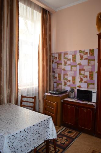 a room with a table and a kitchen with a table and a window at Пляц Пруса/Plac Prus in Lviv