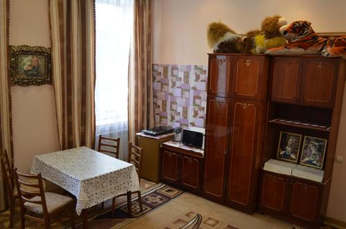 a living room with a table and a cabinet at Пляц Пруса/Plac Prus in Lviv