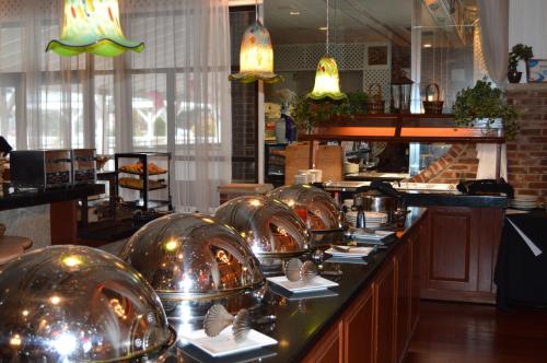 a row of silver domes on a counter in a restaurant at Best Western Plus Wilkes Barre Center City in Wilkes-Barre