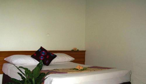 a bedroom with a bed with a pillow on it at Hexagon International Hotel, Villas & Spa in Nadi