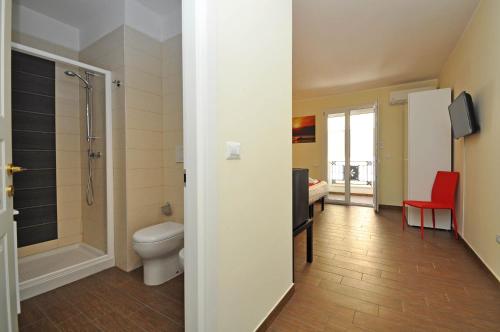 a bathroom with a toilet and a walk in shower at Felicity Residence in Gallipoli