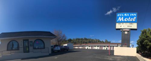 a gas station with a sign for a motel at Relax Inn in Flagstaff