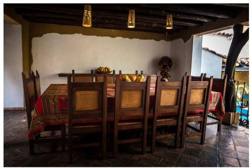 a dining room with a table with chairs and a tableablish at Hotel Boutique Quinta Tibigaro in San Vicente de Chucurí