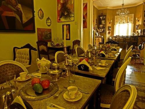 a dining room with a table with food on it at Casa Falleri Boutique Hotel in Lima