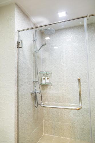 a shower with a glass door in a bathroom at Sandy Beach Condo 17D in Cha Am
