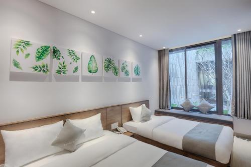 Giường trong phòng chung tại Fanta Suite Villa