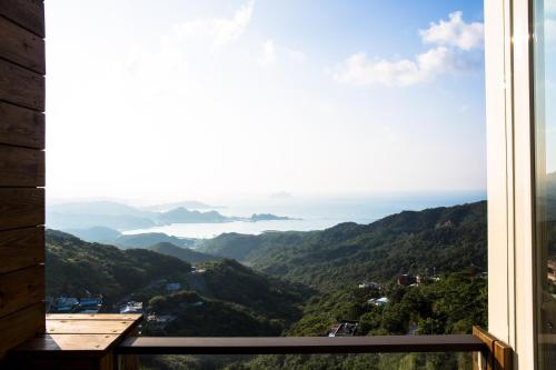 a window view of the ocean from a mountain at Something Easy Inn in Jiufen