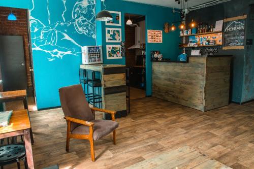 a blue room with a chair and a bar at Montana hostel in Irkutsk