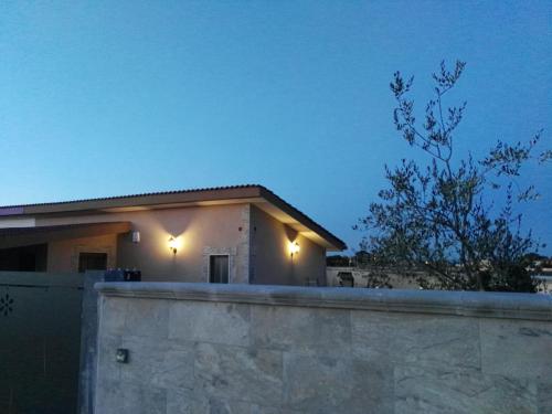 a house with lights on top of a wall at B&B Villa Venere in Taranto