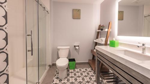 a bathroom with a shower and a toilet and a sink at Lexen Hotel - North Hollywood Near Universal Studios in North Hollywood