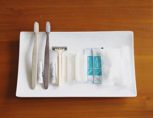 a white plate with utensils on a table at Something Easy Inn in Jiufen