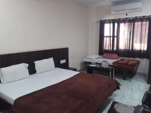 a bedroom with a large bed and a couch at Laxmi Mahal in Udaipur