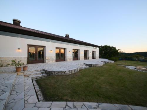 a large white building with a yard in front of it at Southern Cross Resort in Ito