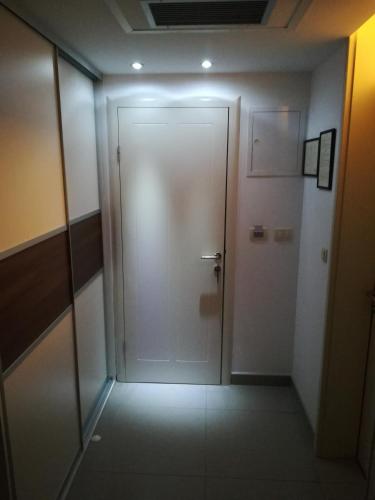 a hallway with a door in a building with lights at Hotel Dina in Međugorje