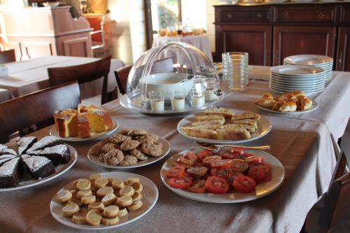 a table topped with plates of pastries and other foods at Tenuta Zannafondo in Donnafugata