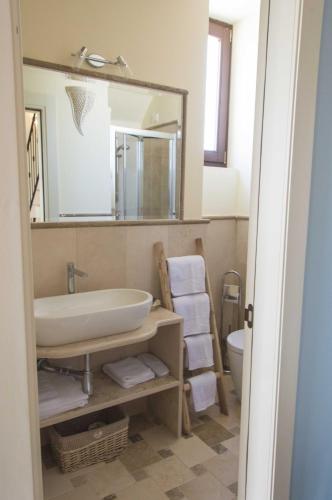a bathroom with a sink and a mirror at Palascìa Wellness Relais in Otranto