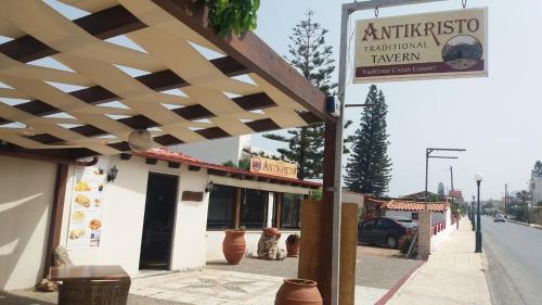 a building with a wooden awning on a street at Antikristo Rooms in Karteros