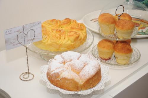 a table with three plates of pastries and cakes at A&B Le Terrazze del Sale' - Apartments in Trento