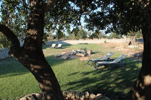 a group of lounge chairs sitting in a park at Tenuta Zannafondo in Donnafugata