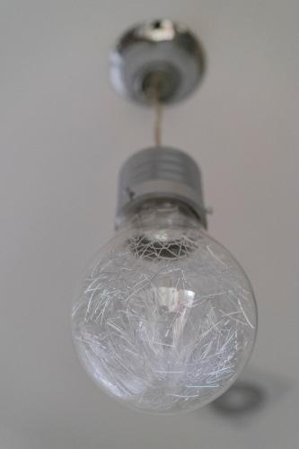 an old glass light bulb hanging from a ceiling at Le Bijou Luxury Rooms & Suites in Veria