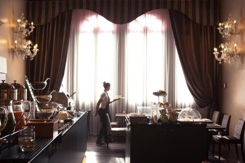 a woman standing in front of a large window at Arcadia Boutique Hotel in Venice