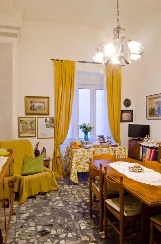 a living room with a table and yellow curtains at Antico Monastero Di Anacapri in Anacapri