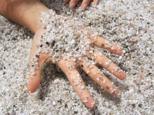 a person laying on the sand with a star made out of gravel at Villa Grantorre in Torre Grande