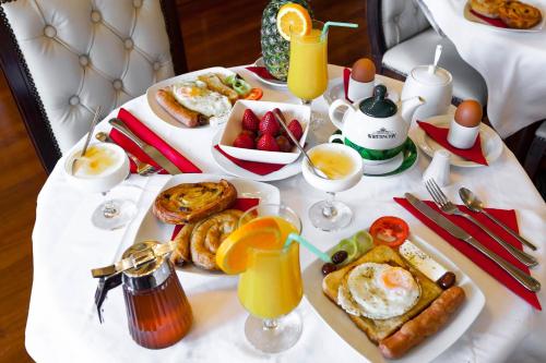 a white table with breakfast foods and drinks on it at Casa Leone Hotel in Chania Town