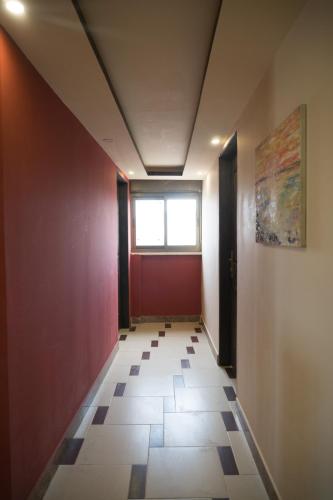 an empty hallway with a window and a tile floor at Madaba Hotel in Madaba