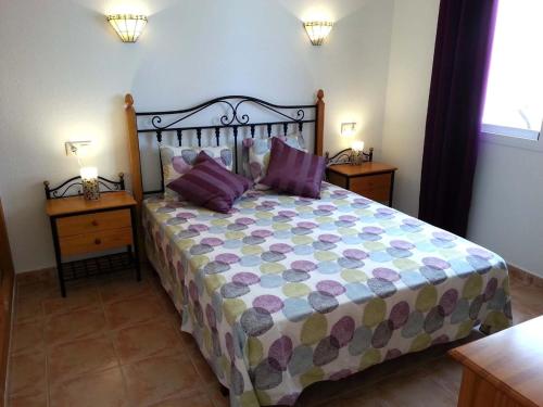 a bedroom with a large bed with two night stands at Apartment Vistamar 2 in Cumbre del Sol