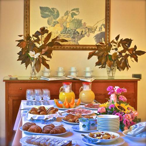 a table topped with plates of food and drinks at Hotel Villa Fiorisella in Marina di Massa