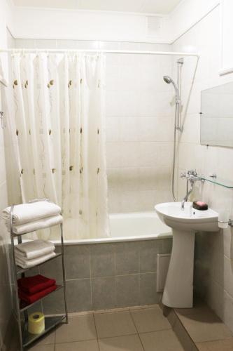a bathroom with a tub and a sink and a toilet at Сонячна in Truskavets
