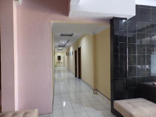 an empty hallway with a hallway leading to a room at Bahari Family Hotel in Bitung