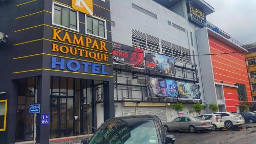 a hotel on a street with cars parked in front of it at Kampar Boutique Hotel in Kampar