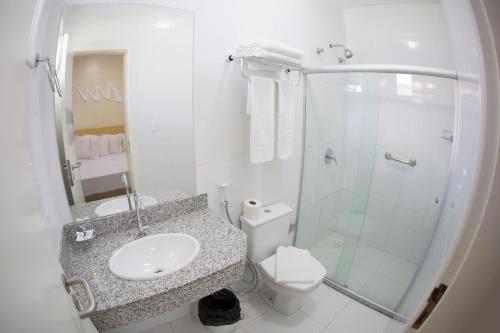 a bathroom with a sink and a shower and a toilet at Hotel Parque das Aguas in Aracaju