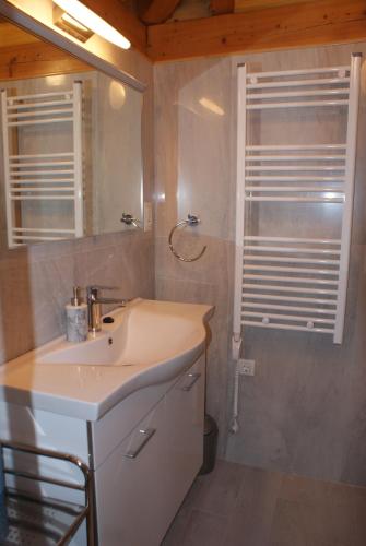 a bathroom with a sink and a mirror at Three oranges in Trsteno