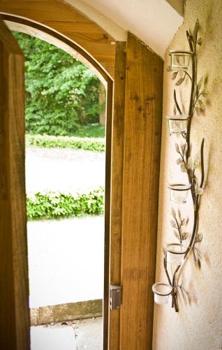 a room with a window and a door with flowers on the wall at Domaine de Keravel in Plouha