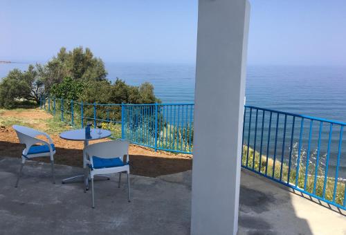 a balcony with a table and chairs and the ocean at A.A Michael Apartments in Pachyammos