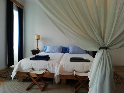 a bedroom with a bed with a canopy at Marina Lounge Home in Ponta Delgada