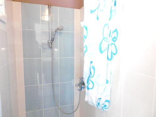 a bathroom with a shower with a shower curtain at Villa Anna in Sarzeau