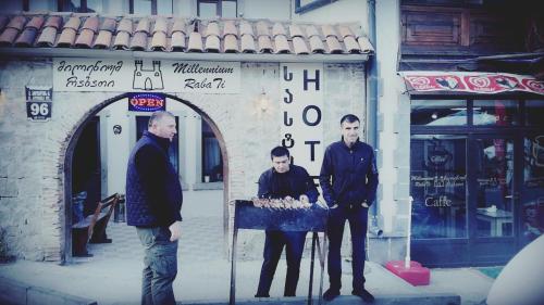 a group of three men standing in front of a building at Millennium Rabati in Akhaltsikhe