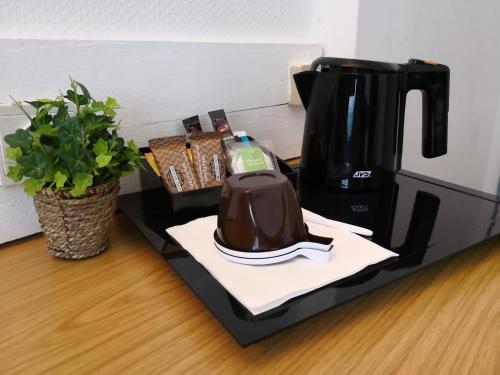 a coffee maker sitting on top of a counter at Logis Hôtel-Restaurant La Coupe d'Or in Lisieux