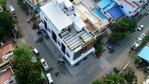 an overhead view of a white building on a street at Vignesh Residency in Tiruchchirāppalli