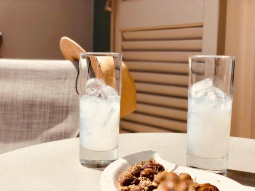 a table with two glasses of water and a plate of food at G George in Nydri