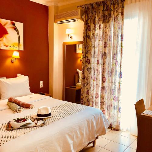 a hotel room with a bed and a window at G George in Nydri
